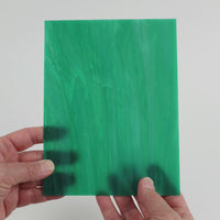 Video of the Sea green glass plate in translucent teal, 15x19cm, held up and tilted to show its pattern and transparency