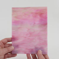 Video of the Pink iridescent glass plate in iridescent translucent pink, 15x19cm, held up and tilted to show its pattern and transparency