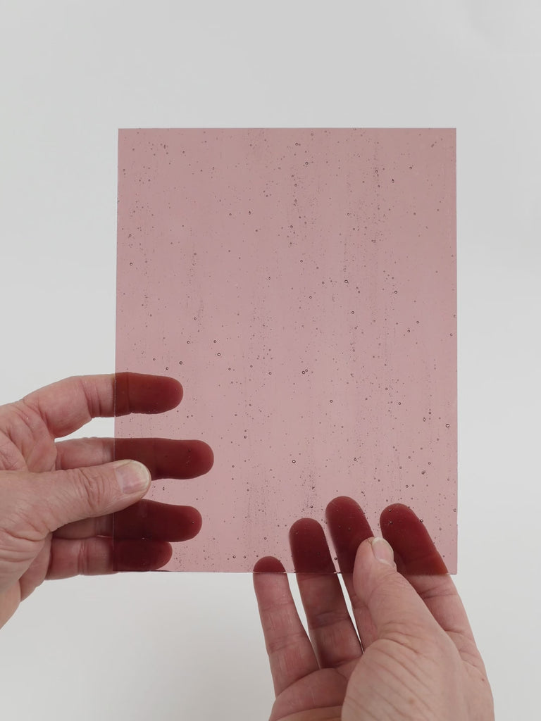Video of the Old Rose glass plate in transparent pink, 15x19cm, held up and tilted to show its pattern and transparency