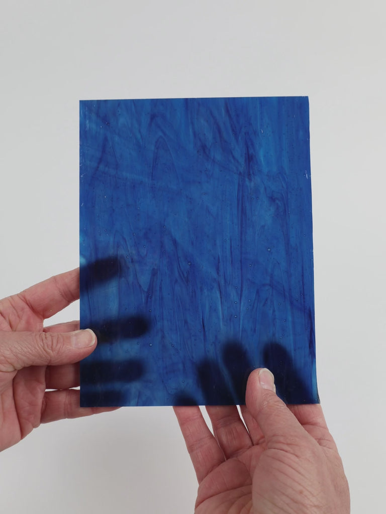 Video of the Ocean Tides glass plate in translucent turquoise, 15x19cm, held up and tilted to show its pattern and transparency
