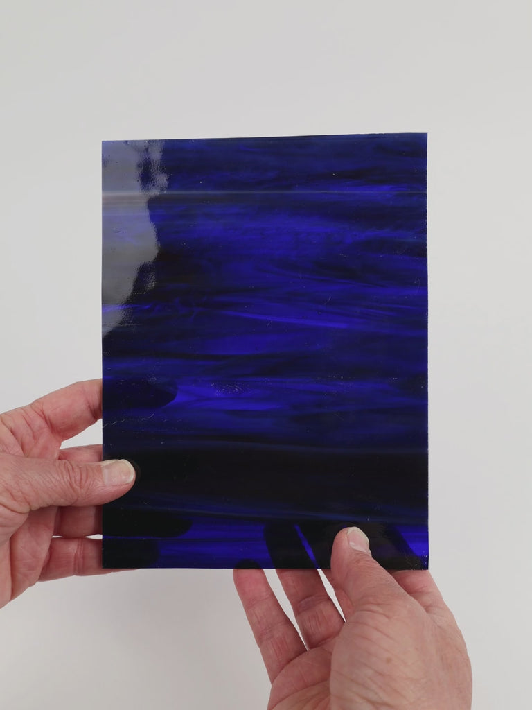 Video of the Mystic glass plate in translucent Red-Violet-Blue, 15x19cm, held up and tilted to show its pattern and transparency