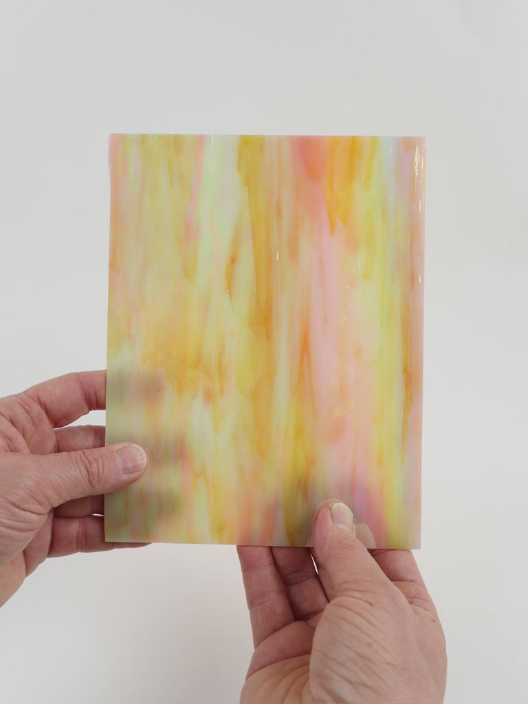 Video of the Peach Pearl glass plate in translucent pink, 15x19cm, held up and tilted to show its pattern and transparency