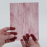 Video of the Violet Wispy glass plate in transparent purple, 15x19cm, held up and tilted to show its pattern and transparency