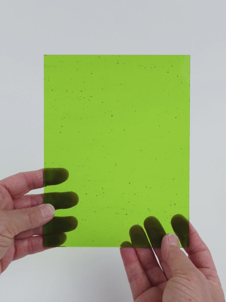 Video of the Deep Lime glass plate in transparent green, 15x19cm, held up and tilted to show its pattern and transparency
