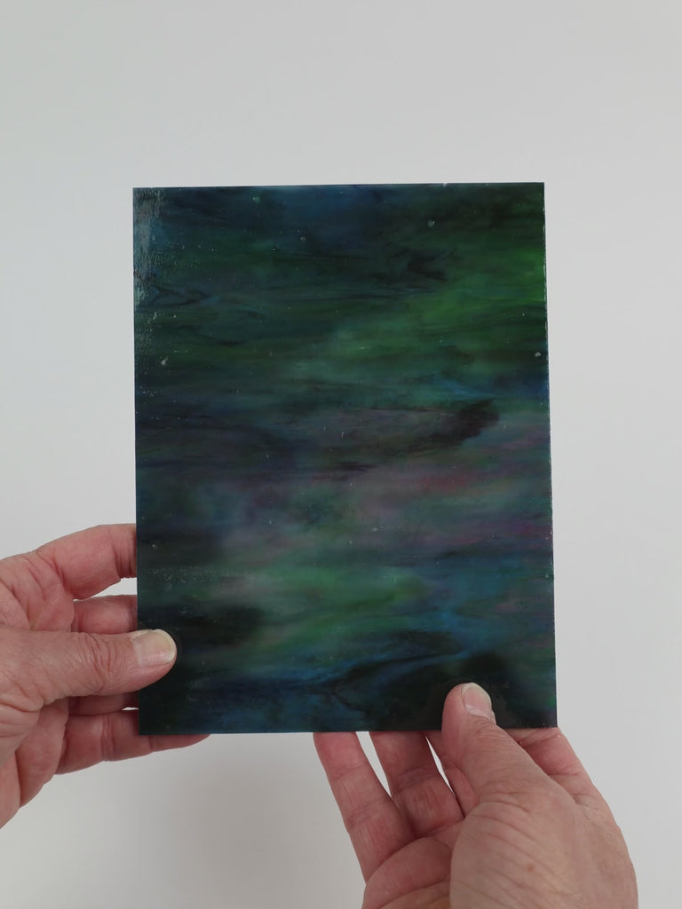 Video of the Indigo rainbow glass plate in translucent blue, 15x19cm, held up and tilted to show its pattern and transparency