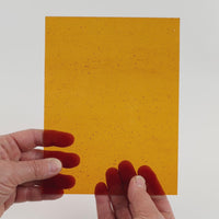 Video of the Deep Amber glass plate in transparant amber, 15x19cm, held up and tilted to show its pattern and transparency