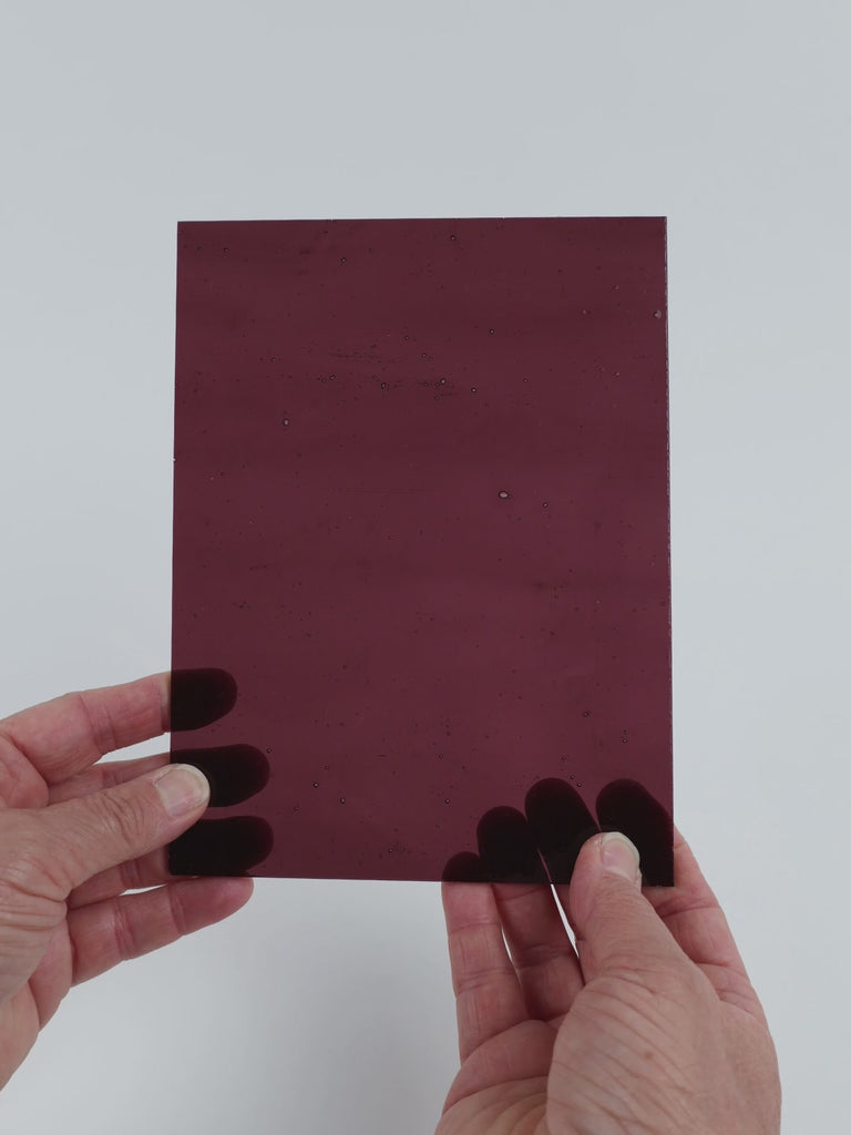Video of the Wine Rose glass plate in transparent purple, 15x19cm, held up and tilted to show its pattern and transparency
