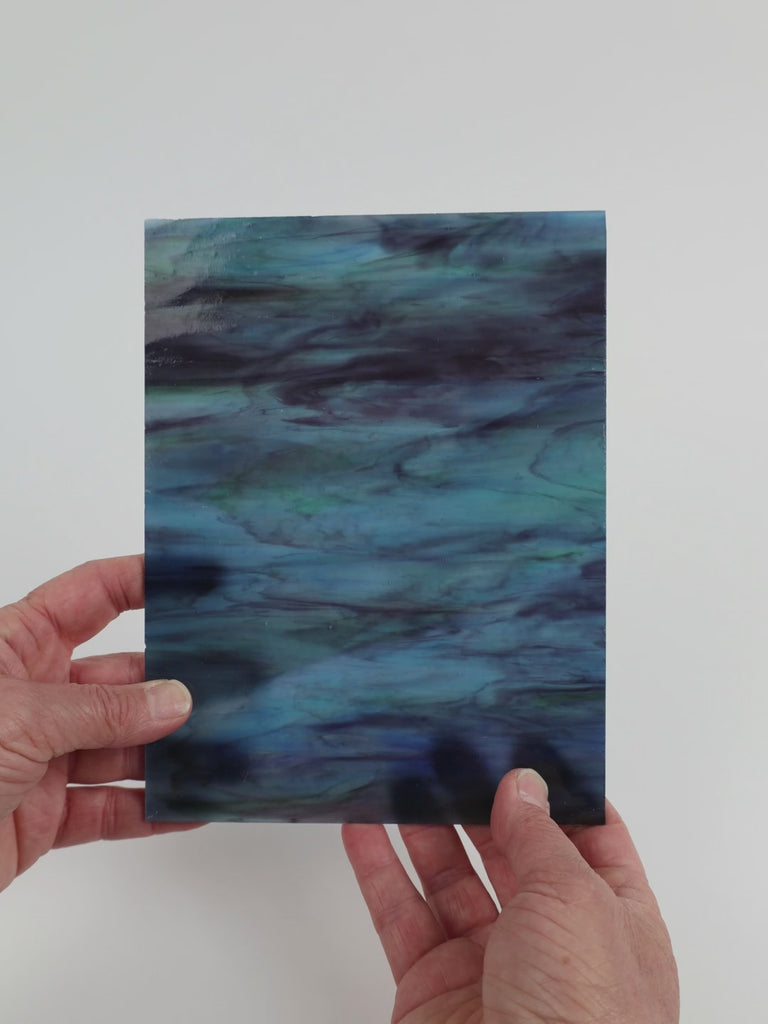 Video of the Indigo Mist glass plate in translucent blue, 15x19cm, held up and tilted to show its pattern and transparency