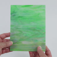 Video of the Mantis Pearlescent glass plate in iridised translucent green, 15x19cm, held up and tilted to show its pattern and transparency