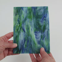 Video of the Mariposa glass plate in translucent blue, 15x19cm, held up and tilted to show its pattern and transparency