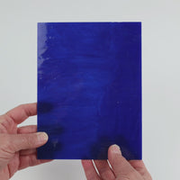 Video of the Cobalt Wispy glass plate in translucent blue, 15x19cm, held up and tilted to show its pattern and transparency