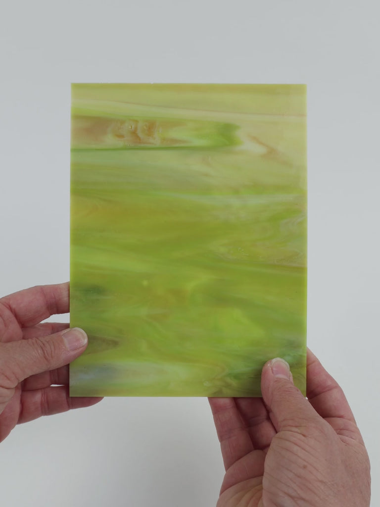 Video of the Pale Lime Marble glass plate in translucent green, 15x19cm, held up and tilted to show its pattern and transparency