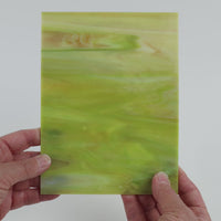 Video of the Pale Lime Marble glass plate in translucent green, 15x19cm, held up and tilted to show its pattern and transparency