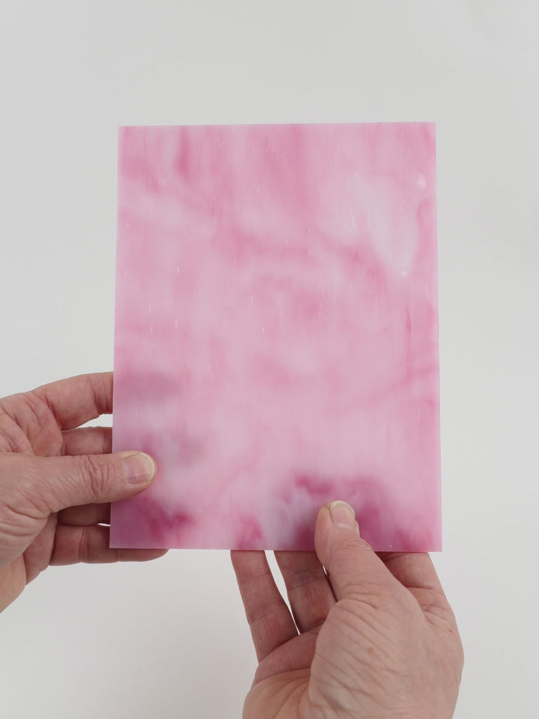 Video of the Sugar Plum glass plate in translucent pink, 15x19cm, held up and tilted to show its pattern and transparency