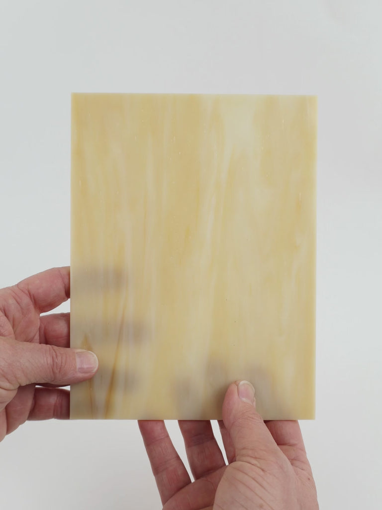 Video of the amber mist glass plate in camel translucent, 15x19cm, held up and tilted to show its pattern and transparency