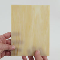 Video of the amber mist glass plate in camel translucent, 15x19cm, held up and tilted to show its pattern and transparency