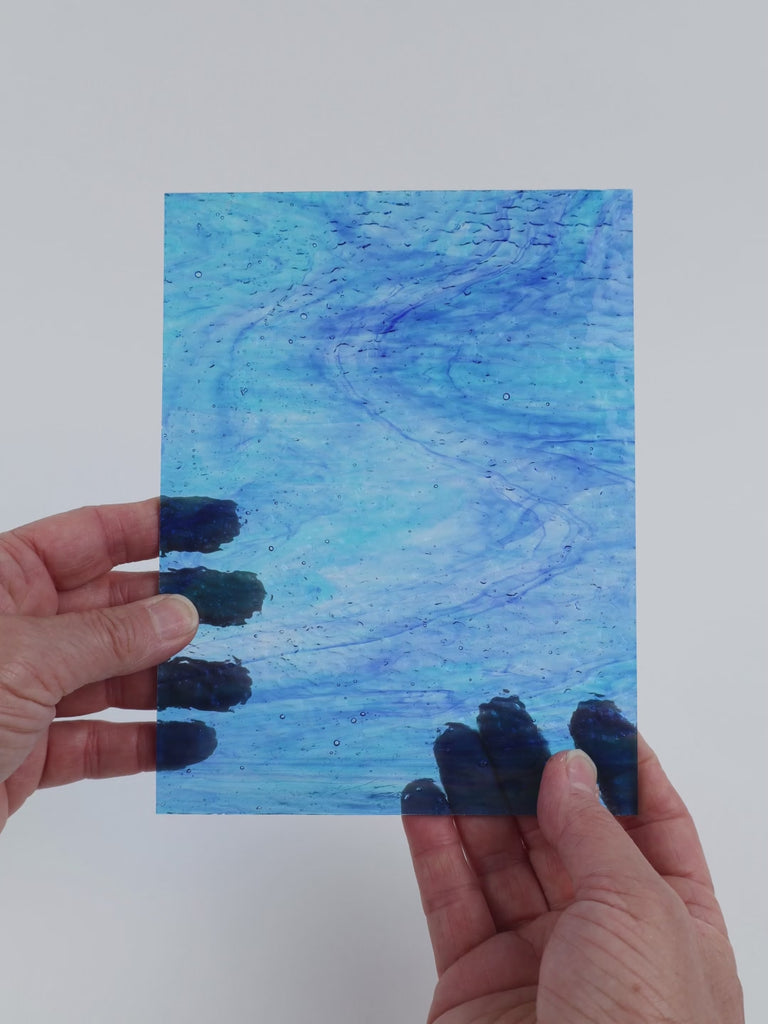 Video of the Pale Turquoise Wave Ripple glass plate in ripple transparent turquoise, 15x19cm, held up and tilted to show its pattern and transparency