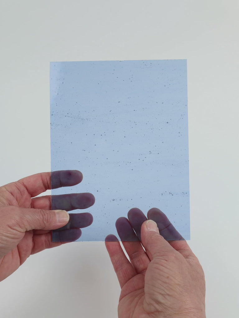 Video of the beached Blue glass plate in transparent blue, 15x19cm, held up and tilted to show its pattern and transparency
