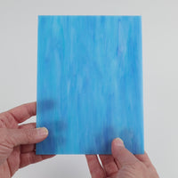 Video of the Blue Turquoise Wispy glass plate in translucent blue, 15x19cm, held up and tilted to show its pattern and transparency